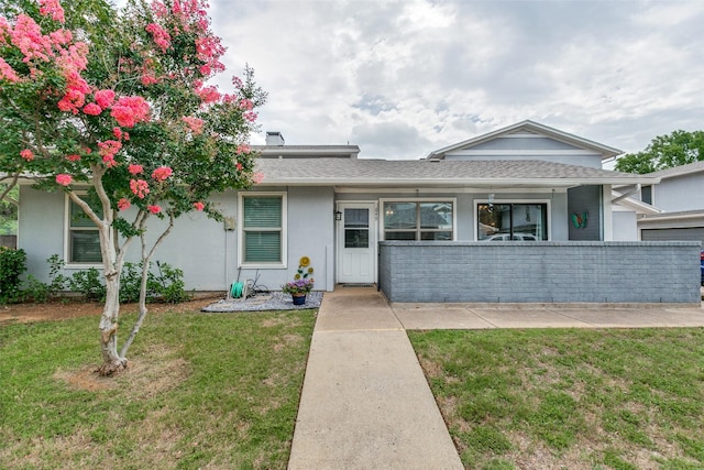 649 Timberline Dr, Hurst, TX 76053 - view of front of property featuring stucco siding and a front yard