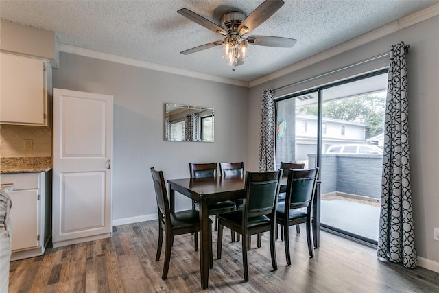 649 Timberline Dr, Hurst, TX 76053 - dining space with wood finished floors, a textured ceiling, ceiling fan, ornamental molding, and baseboards