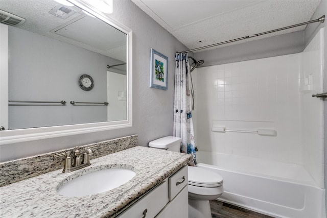 649 Timberline Dr, Hurst, TX 76053 - bathroom featuring shower / bath combination with curtain, toilet, vanity, wood finished floors, and a textured ceiling