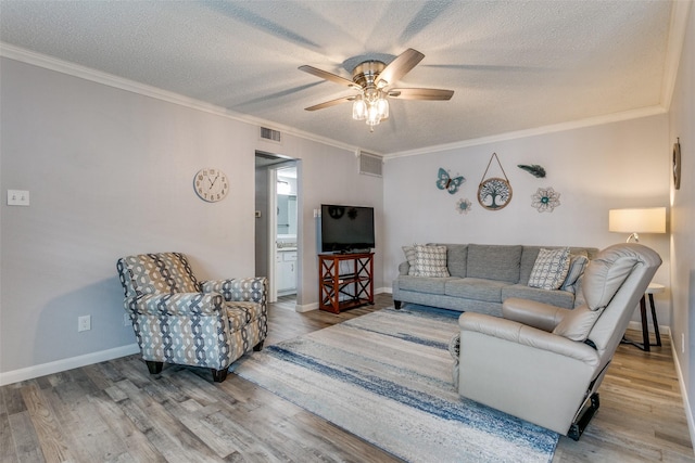 649 Timberline Dr, Hurst, TX 76053 - living area featuring ceiling fan, a textured ceiling, wood finished floors, ornamental molding, and baseboards