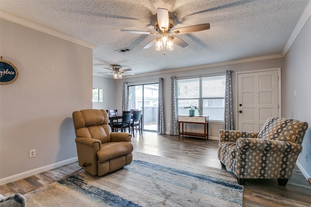 649 Timberline Dr, Hurst, TX 76053 - living room with a textured ceiling, wood finished floors, ceiling fan, ornamental molding, and baseboards