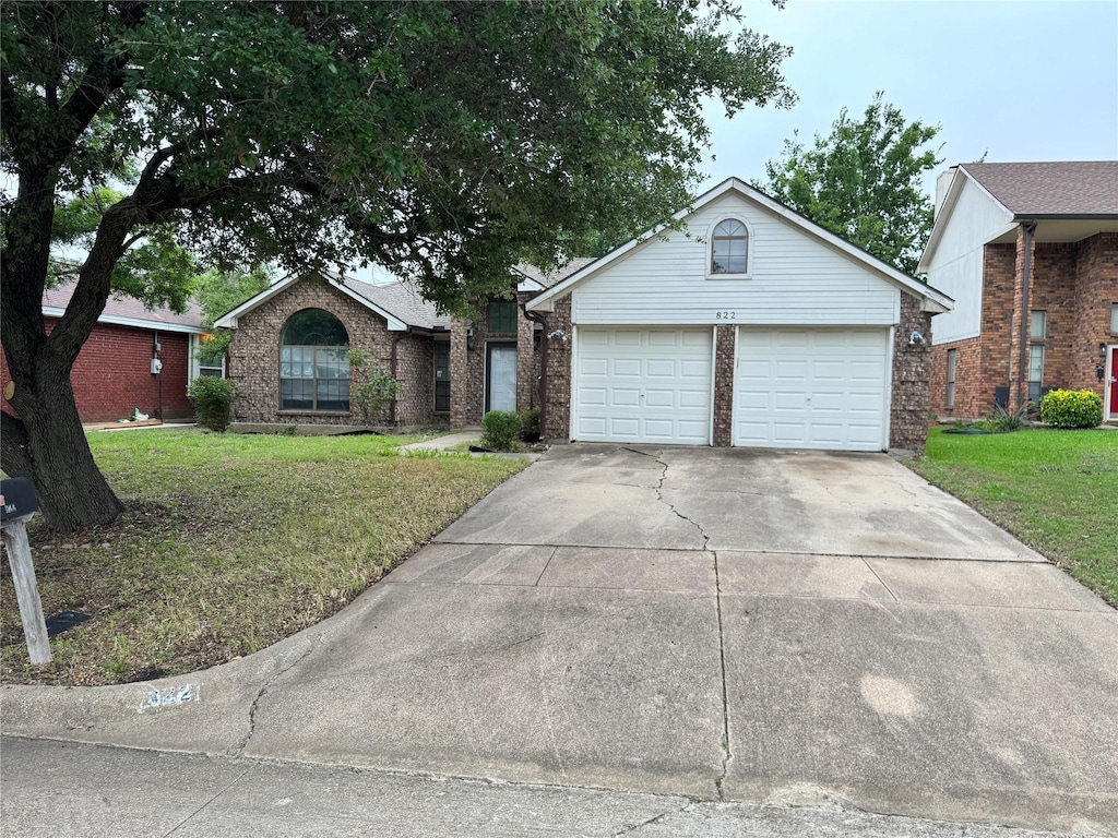 822 Trevor Way, Arlington, TX 76001 - view of front of home featuring a front lawn, driveway, brick siding, and an attached garage