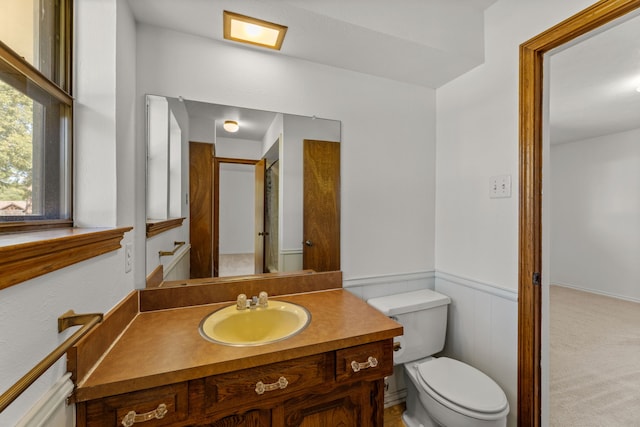 208 Ashe Bend Dr, Rowlett, TX 75087 - bathroom featuring toilet, vanity, and wainscoting