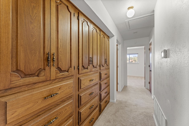 208 Ashe Bend Dr, Rowlett, TX 75087 - hall featuring light carpet, attic access, baseboards, and a textured wall