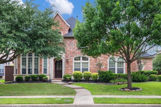 1331 Crockett Dr, Frisco, TX 75033 - view of front of home featuring a front yard, brick siding, and roof with shingles