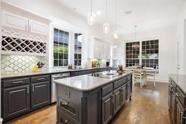 1331 Crockett Dr, Frisco, TX 75033 - kitchen with stainless steel dishwasher, black electric stovetop, white cabinetry, ornamental molding, and tasteful backsplash