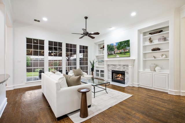 1331 Crockett Dr, Frisco, TX 75033 - living room with a fireplace, built in features, crown molding, ceiling fan, and wood finished floors