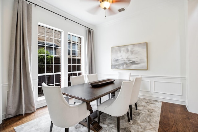 1331 Crockett Dr, Frisco, TX 75033 - dining space with wood finished floors, ceiling fan, crown molding, and wainscoting