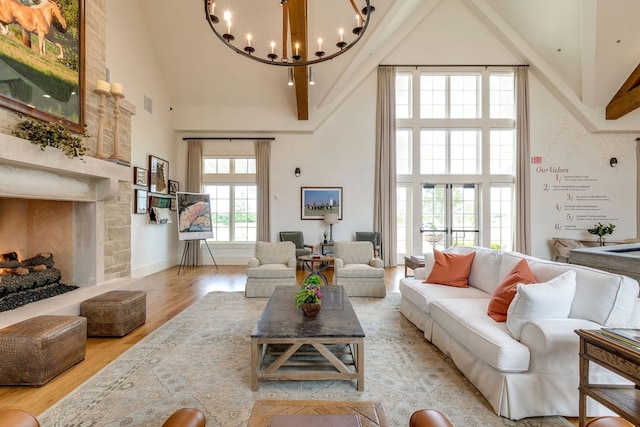4229 Palomino Rd, Aubrey, TX 76227 - living area with high vaulted ceiling, wood finished floors, a chandelier, a fireplace with raised hearth, and baseboards