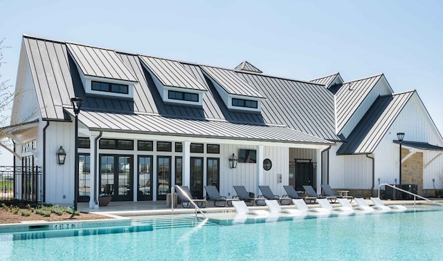 4229 Palomino Rd, Aubrey, TX 76227 - rear view of house with a standing seam roof, a community pool, and metal roof