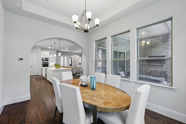 125 Chisholm Trl, Highland Village, TX 75077 - dining area featuring a chandelier, arched walkways, baseboards, dark wood finished floors, and recessed lighting