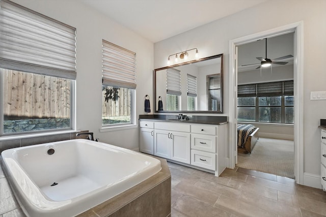 125 Chisholm Trl, Highland Village, TX 75077 - bathroom with vanity, a freestanding tub, ceiling fan, and baseboards