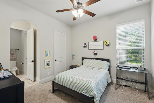 125 Chisholm Trl, Highland Village, TX 75077 - bedroom featuring light colored carpet, arched walkways, baseboards, and ensuite bathroom