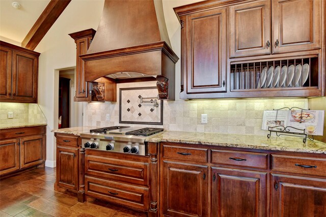 128 Whispering Winds Dr, Gunter, TX 75058 - kitchen featuring stainless steel gas stovetop, custom range hood, decorative backsplash, and light stone counters