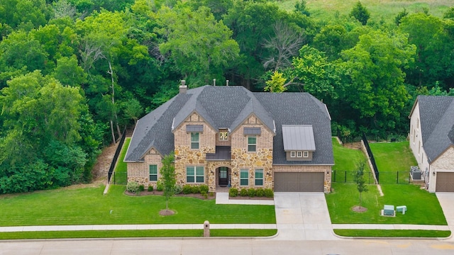 1416 Bearpath Way, Gunter, TX 75058 - view of front facade featuring stone siding, concrete driveway, a chimney, and a standing seam roof