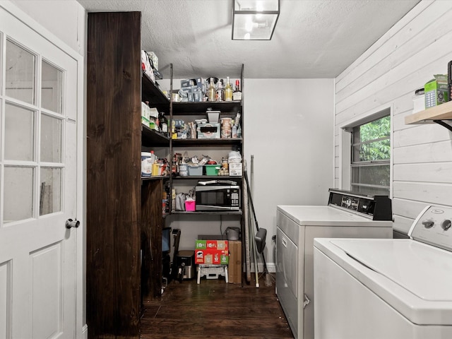 536 Nathan St, Burleson, TX 76028 - washroom with washer and dryer, dark wood-style flooring, wooden walls, and a textured ceiling