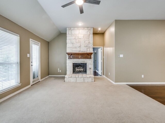 3604 Camino Trl, Mckinney, TX 75070 - unfurnished living room featuring a ceiling fan, plenty of natural light, a stone fireplace, baseboards, and vaulted ceiling