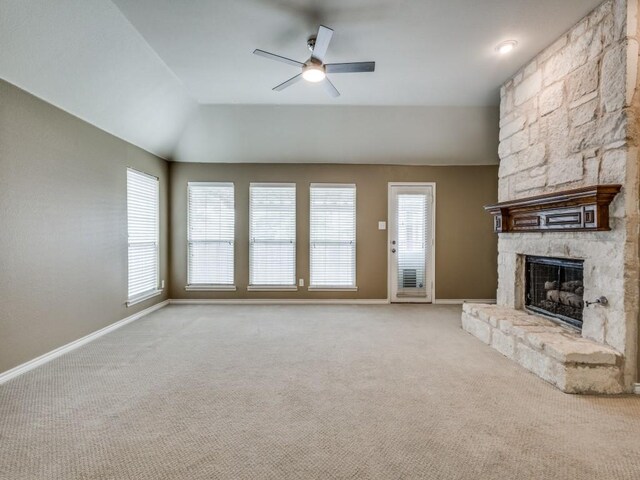 3604 Camino Trl, Mckinney, TX 75070 - unfurnished living room with a stone fireplace, a ceiling fan, carpet flooring, baseboards, and lofted ceiling