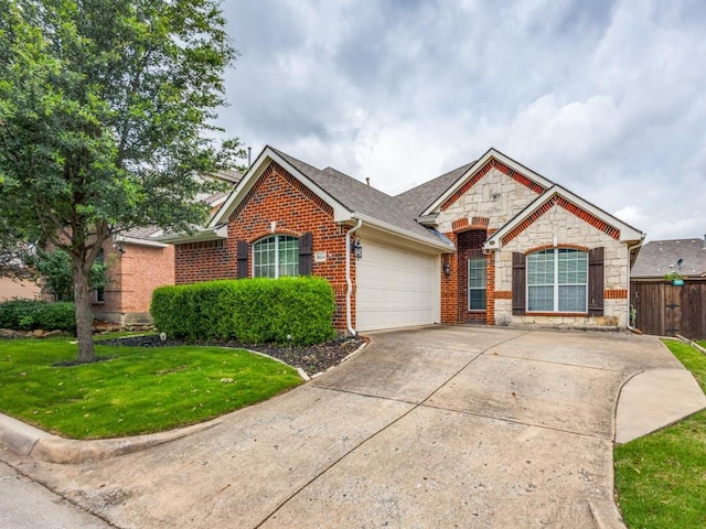 3604 Camino Trl, Mckinney, TX 75070 - view of front of home featuring an attached garage, brick siding, stone siding, concrete driveway, and roof with shingles
