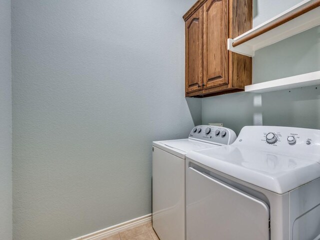 3604 Camino Trl, Mckinney, TX 75070 - washroom featuring washer and dryer, cabinet space, baseboards, and light tile patterned floors