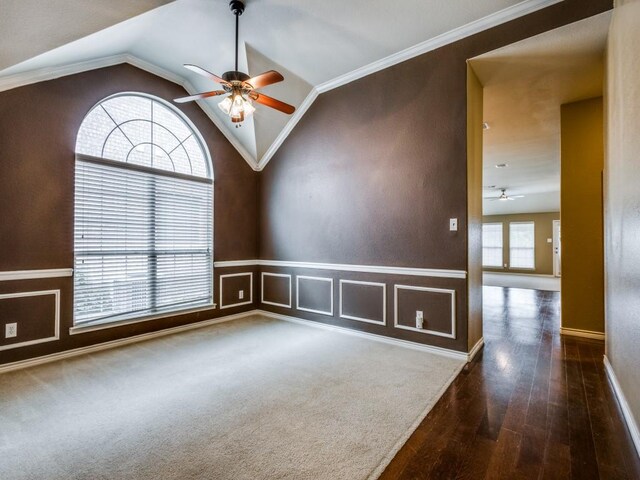 3604 Camino Trl, Mckinney, TX 75070 - empty room featuring a ceiling fan, wood finished floors, vaulted ceiling, a wainscoted wall, and baseboards