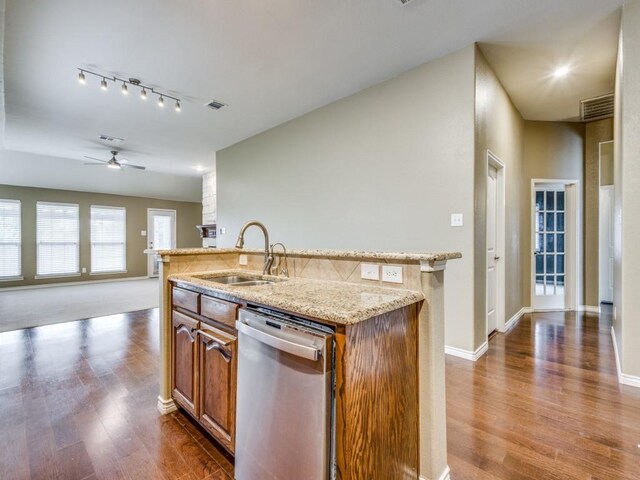 3604 Camino Trl, Mckinney, TX 75070 - kitchen featuring stainless steel dishwasher, a sink, dark wood finished floors, brown cabinets, and ceiling fan