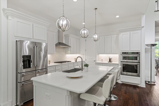 10933 Smoky Oak Trl, Flower Mound, TX 76226 - kitchen with stainless steel appliances, a sink, wall chimney exhaust hood, an island with sink, and tasteful backsplash