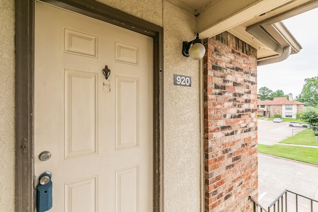 920 Turtle Cv Unit 252, Irving, TX 75060 - property entrance with stucco siding, brick siding, and a porch