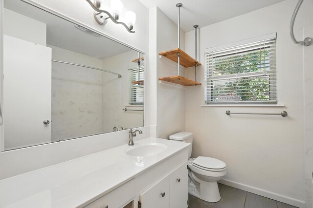 809 Harwell St, Abilene, TX 79601 - full bath with toilet, vanity, a shower, and baseboards
