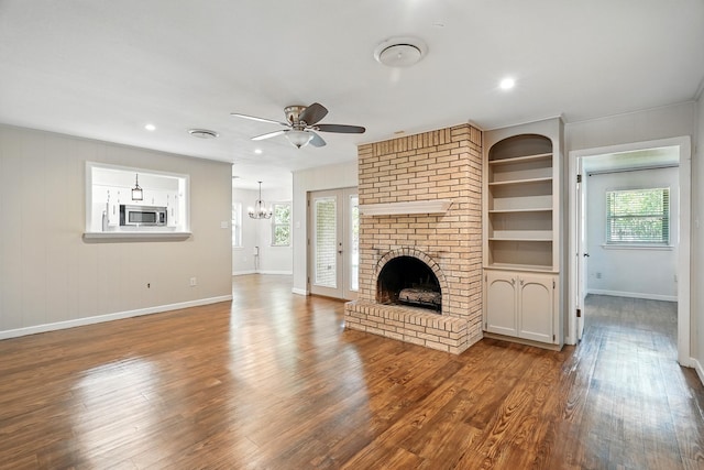 809 Harwell St, Abilene, TX 79601 - unfurnished living room with ceiling fan, baseboards, wood finished floors, a fireplace, and built in features