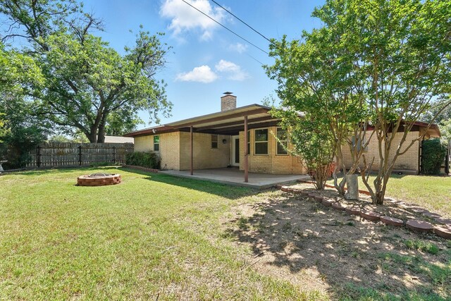 809 Harwell St, Abilene, TX 79601 - back of house with an outdoor fire pit, brick siding, a chimney, and a patio