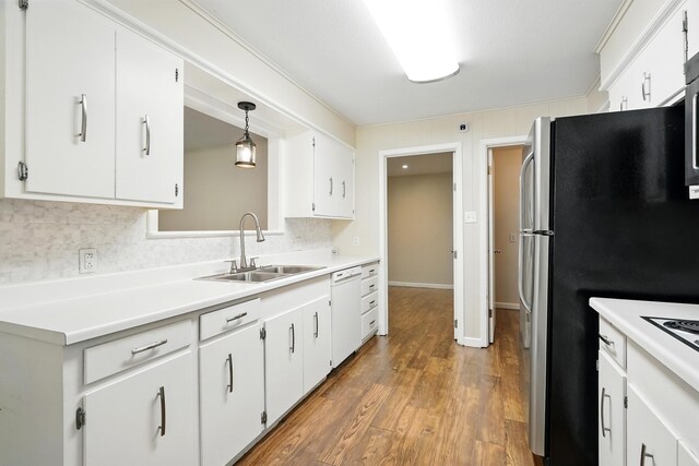 809 Harwell St, Abilene, TX 79601 - kitchen with a sink, dishwasher, decorative backsplash, light countertops, and white cabinets