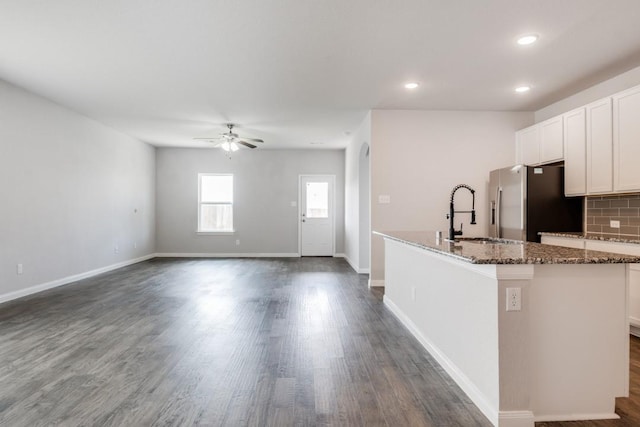 2089 Hartley Dr, Forney, TX 75126 - kitchen featuring stainless steel fridge with ice dispenser, a ceiling fan, dark stone counters, a sink, and an island with sink