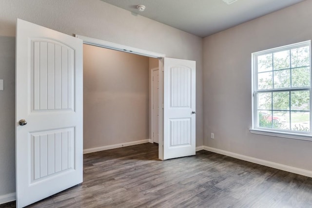 2089 Hartley Dr, Forney, TX 75126 - unfurnished bedroom with wood finished floors and baseboards
