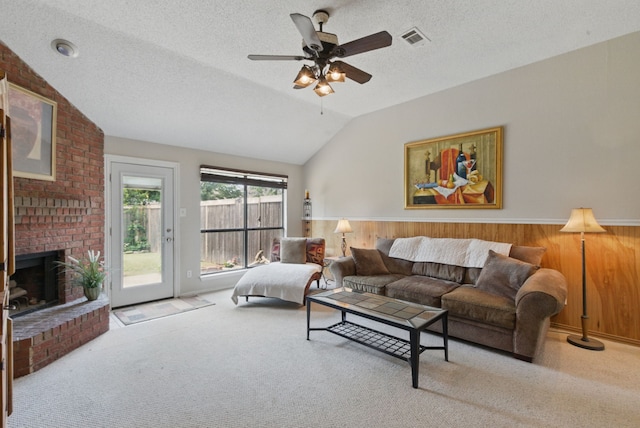 1508 Haven Pl, Allen, TX 75002 - living area featuring lofted ceiling, a textured ceiling, a fireplace, carpet flooring, and wainscoting