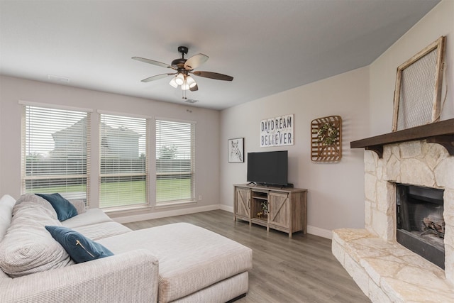 2014 Slow Stream Dr, Royse City, TX 75189 - living area with baseboards, a ceiling fan, light wood finished floors, and a fireplace