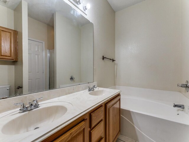 7116 Park Creek Cir E, Fort Worth, TX 76137 - full bathroom featuring a bath, toilet, double vanity, and a shower with shower door