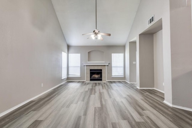 9736 Old Field Dr, Mckinney, TX 75072 - unfurnished living room featuring ceiling fan, wood finished floors, a fireplace, baseboards, and high vaulted ceiling
