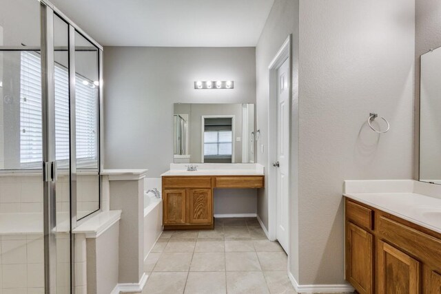 9736 Old Field Dr, Mckinney, TX 75072 - full bathroom featuring two vanities, a garden tub, tile patterned floors, and a shower stall