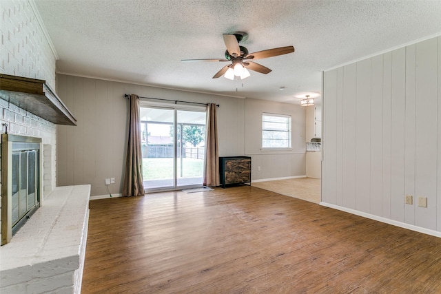1816 Chattanooga, Bedford, TX 76021 - unfurnished living room with a fireplace, wood finished floors, ceiling fan, crown molding, and a textured ceiling