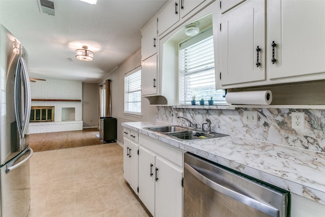 1816 Chattanooga, Bedford, TX 76021 - kitchen with stainless steel appliances, a sink, white cabinetry, light countertops, and tasteful backsplash