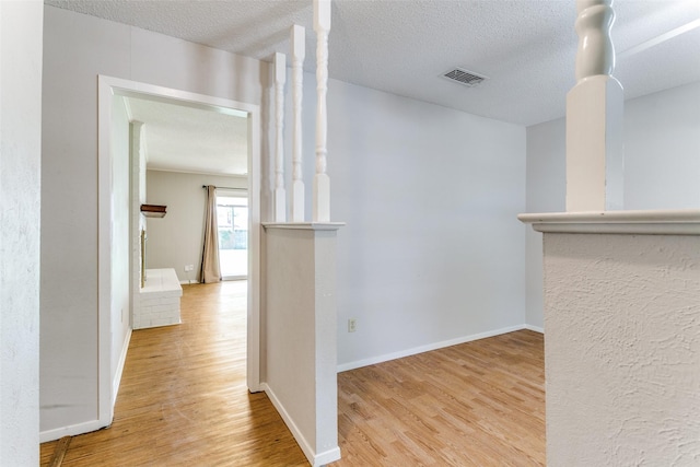 1816 Chattanooga, Bedford, TX 76021 - corridor featuring wood finished floors, baseboards, and a textured ceiling