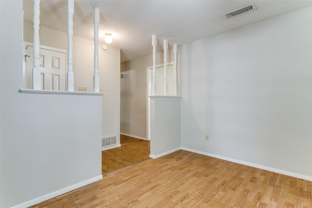 1816 Chattanooga, Bedford, TX 76021 - spare room featuring wood finished floors, baseboards, and a textured ceiling