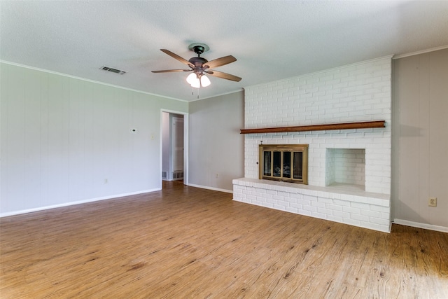 1816 Chattanooga, Bedford, TX 76021 - unfurnished living room featuring ceiling fan, a fireplace, wood finished floors, ornamental molding, and baseboards