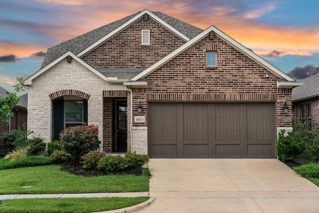 1615 Sweetwater Way, Celina, TX 75009 - french country inspired facade featuring roof with shingles, concrete driveway, brick siding, a garage, and stone siding