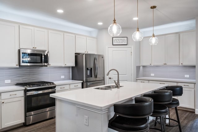 1615 Sweetwater Way, Celina, TX 75009 - kitchen with stainless steel appliances, a sink, tasteful backsplash, dark wood-style floors, and a breakfast bar