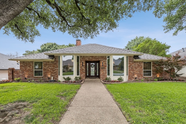 9620 Vista Oaks Dr, Dallas, TX 75243 - view of front of home featuring a chimney, a front yard, and brick siding