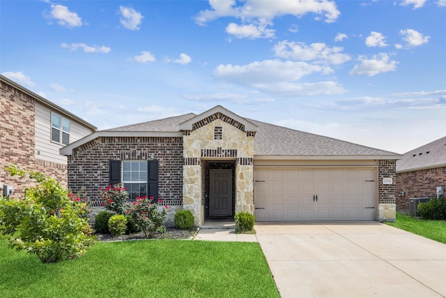 2224 Heaton St, Forney, TX 75126 - view of front facade featuring concrete driveway, a garage, a front yard, and brick siding