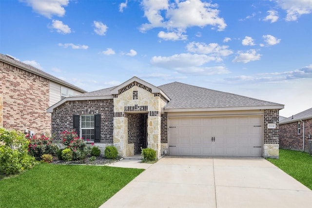 2224 Heaton St, Forney, TX 75126 - view of front of house with driveway, an attached garage, stone siding, and a front lawn