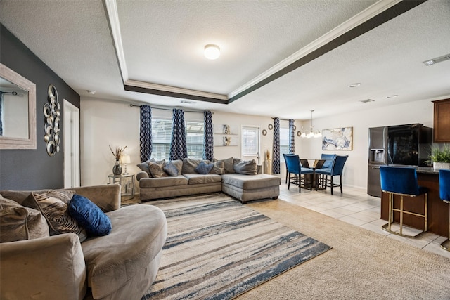 2224 Heaton St, Forney, TX 75126 - living area with a textured ceiling, light tile patterned floors, a tray ceiling, ornamental molding, and a chandelier